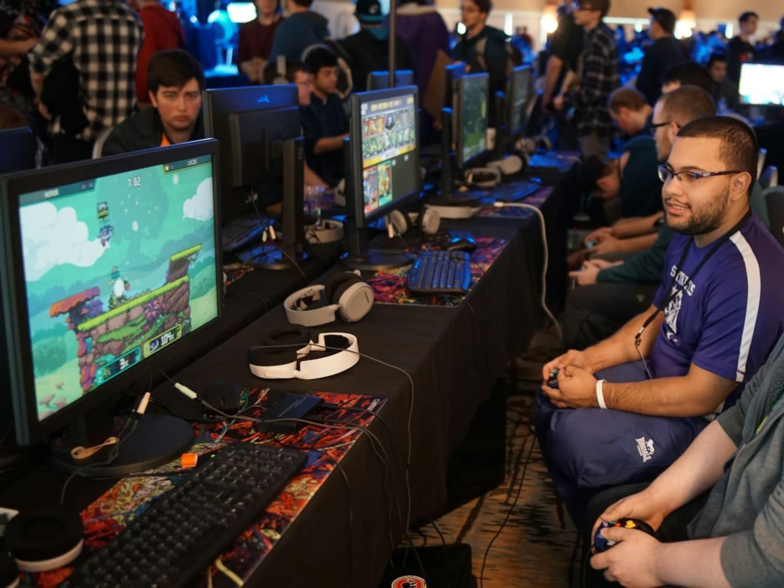 Players at rows of computers competing at a gaming tournament