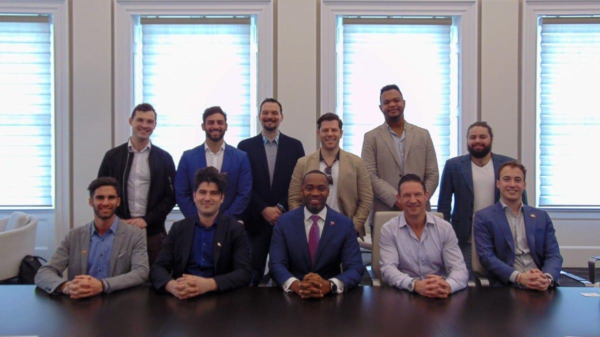 The Bidali team and delegation seated around a boardroom table with the Premier of Bermuda.