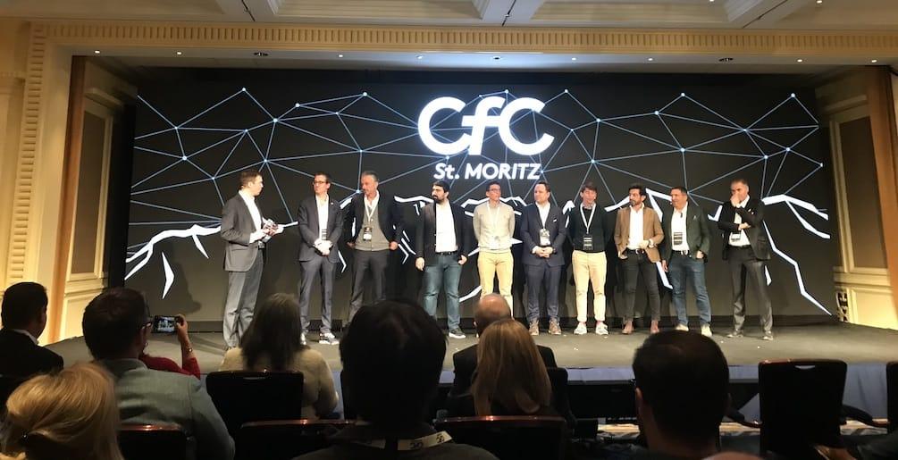 Founders lined up on the CfC St. Moritz stage in front of a network graphic.